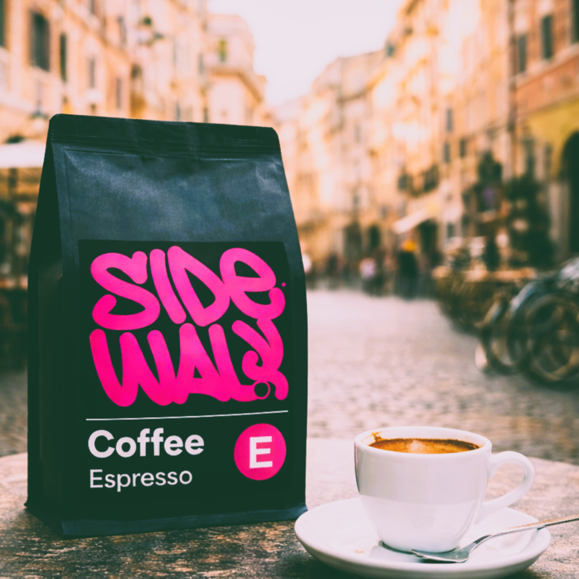 Coffee bag labeled 'SIDEWALK Coffee Espresso' with a cup of coffee on a blurred street background