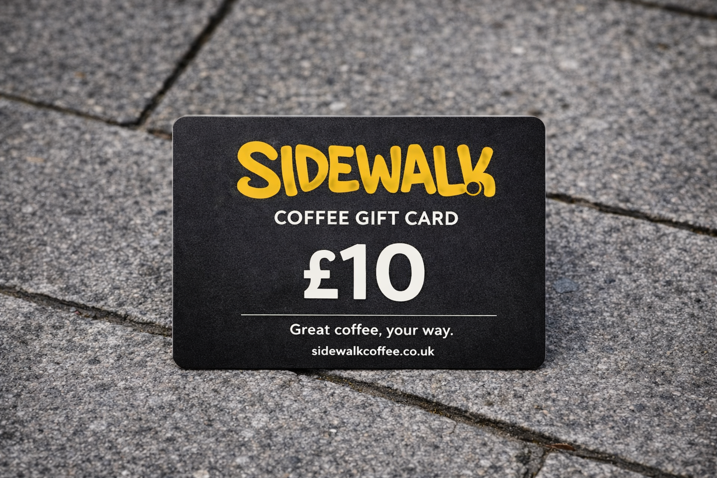 Sidewalk Coffee gift card worth £10 on a pavement background