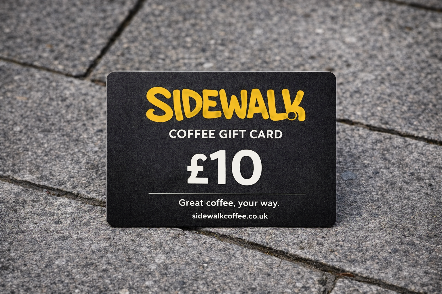 Sidewalk Coffee gift card worth £10 on a pavement background